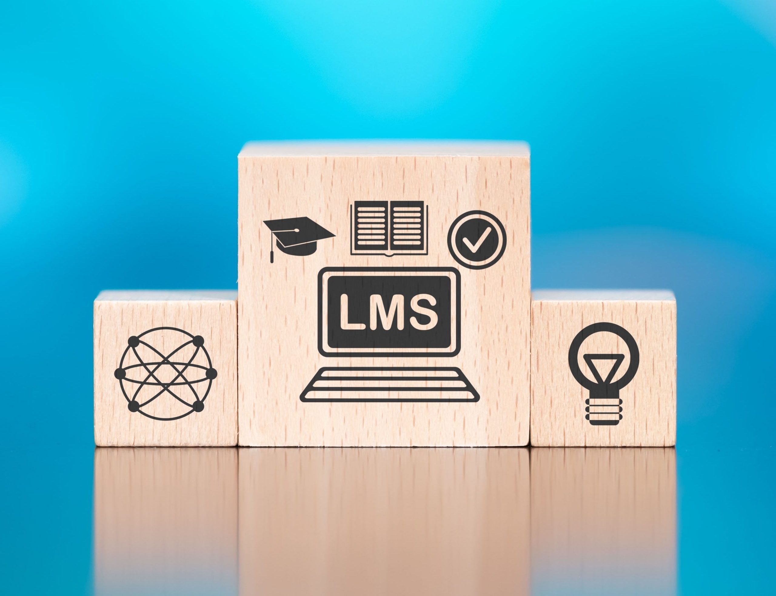 Wooden,Blocks,With,Symbol,Of,Lms,Concept,On,Blue,Background
